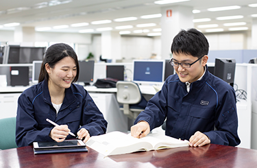 写真：先輩と仕事中の堂本さん