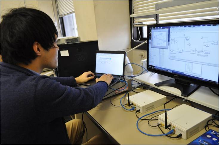 Student working on a wireless transmission experiment using the USRP software radio kit.